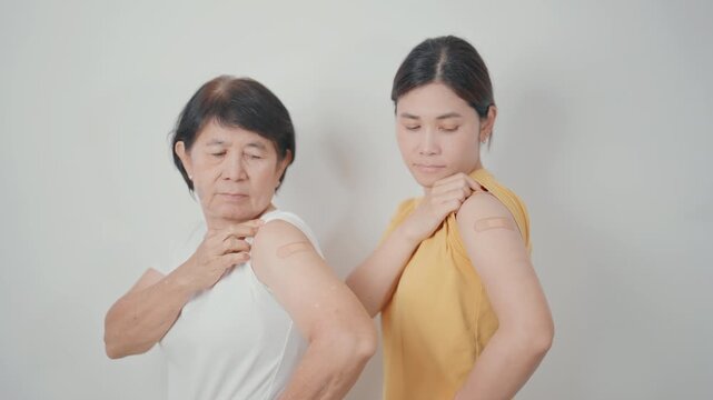 Adult and Elderly Woman with bandage after received vaccine. Vaccination and Immunization for Influenza, HPV, Zoster, IPD, DTP, Dengue, Encephalitis, Rabies, Pneumococcal Hepatitis B and Covid vaccine