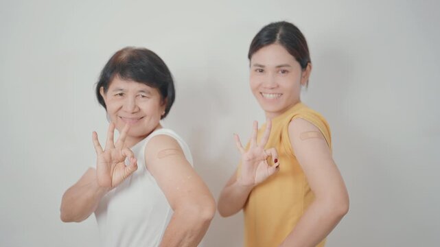 Adult and Elderly Woman with bandage after received vaccine. Vaccination and Immunization for Influenza, HPV, Zoster, IPD, DTP, Dengue, Encephalitis, Rabies, Pneumococcal Hepatitis B and Covid vaccine