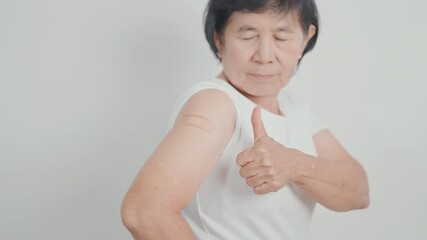 Elderly Woman with bandage after received vaccine. Vaccination and Immunization for Influenza, Herpes Zoster, Tetanus, Covid 19 booster, Dengue, Encephalitis, Rabies, Pneumococcal, IPD, RSV Vaccines