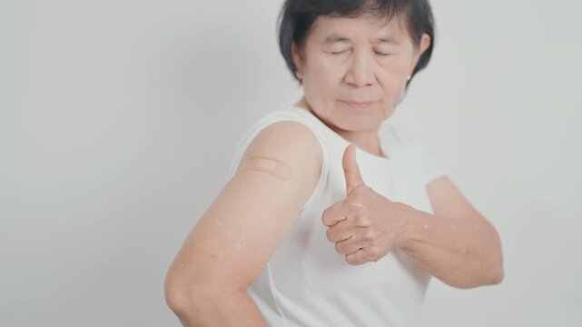 Elderly Woman with bandage after received vaccine. Vaccination and Immunization for Influenza, Herpes Zoster, Tetanus, Covid 19 booster, Dengue, Encephalitis, Rabies, Pneumococcal, IPD, RSV Vaccines