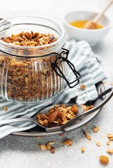 Healthy homemade granola breakfast cereal in glass jar