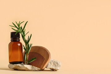 Composition with wooden hair comb, rosemary twig, stones and bottle of cosmetic product on beige background, closeup