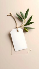 Tag and olive branch on beige backdrop, minimalist and simple