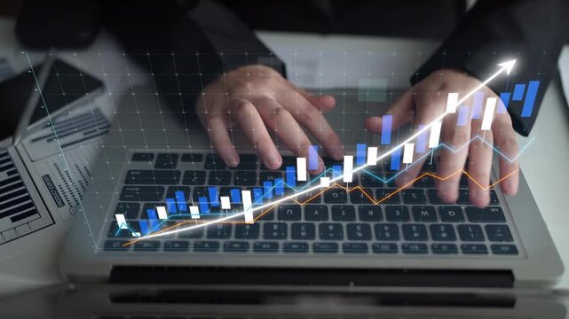 A business professional uses a laptop to analyze financial data represented by charts and graphs, showcasing growth trends and strategic insights in a modern office environment. Copula