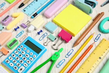Blank sticky notes and school supplies on white wooden background, closeup