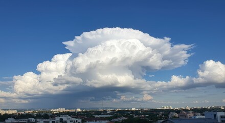 Dramatic cloud formation against a clear blue sky creating dynamic weather landscape for atmospheric illustration