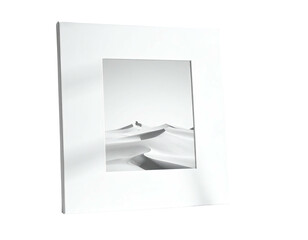 A square white frame surrounds a monochrome image of sand dunes