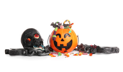 Cauldron in shape of pumpkin with candies for Halloween, chains and skull isolated on white...