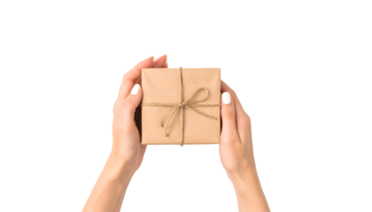 Womans hands holding a gift box wrapped in brown paper isolated on transparent background