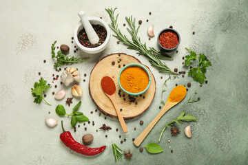 Different herbs and spices on green grunge background