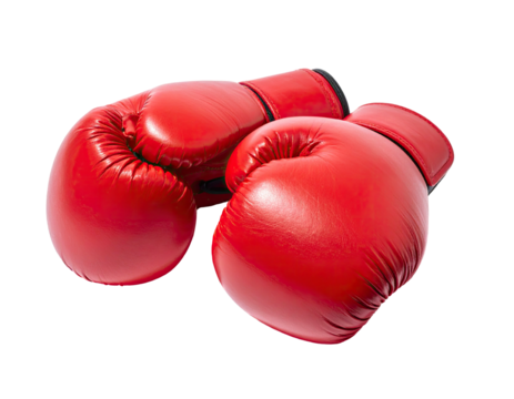 Two bright red boxing gloves laid on a dark backdrop, close-up