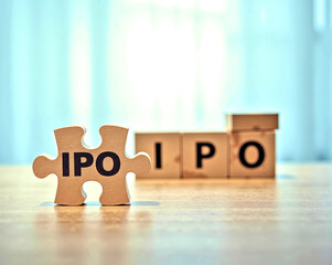 Wooden Puzzle Piece with IPO Text on Table and Letters Box