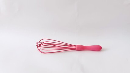 Pink whisk pops against sleek white kitchen for modern food prep. Clean, playful, and perfect for upbeat culinary scenes with bold visual contrast - Powered by Adobe