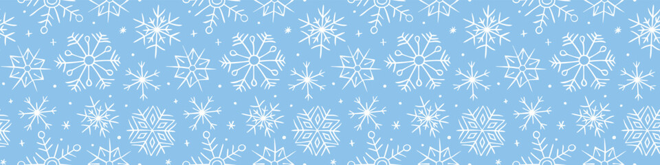 Vector seamless pattern from hand drawn snowflakes in doodle style. Winter, Christmas, new year blue background and texture. Snowfall, blizzard.