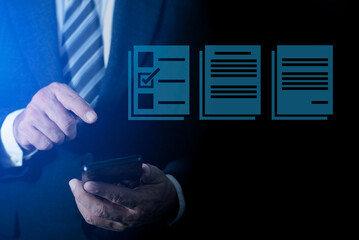 Businessman using pen to mark checkboxes, Performance checklist and tracking business performance, Online survey online exam Choosing the right answer in the exam.