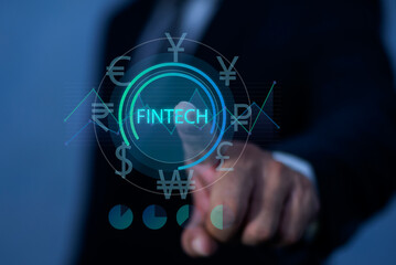 Business man touched FINTECH text on virtual touch screen. Fintech -financial technology concept. On line Banking, Stock trading.