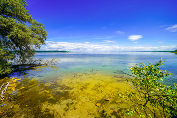 View of Lake Chiemsee and the surrounding landscape. Nature by the lake in Bavaria.
