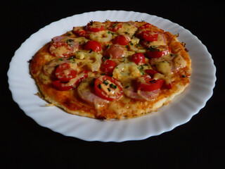 Individual Homemade Pizza on White Plate, Black Background