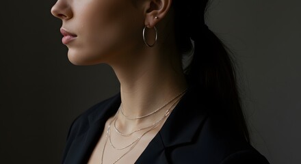 Elegant Woman with Silver Jewelry: Necklace and Hoop Earrings
