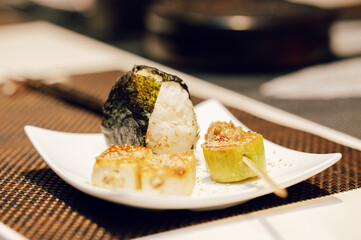 Japanese rice ball and miso dengaku tofu on a white plate — homemade comfort food