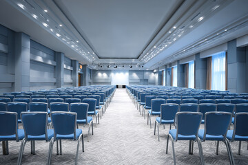 Obraz premium Large empty conference hall with rows of chairs and stage screen