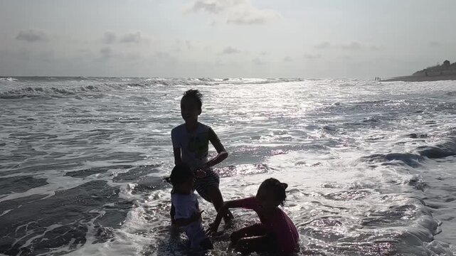 Brother and litle sister swim in the beach