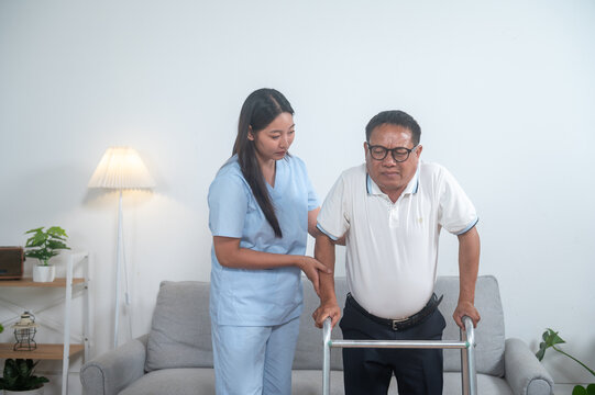 Supporting Independence: A dedicated caregiver assists an elderly gentleman with a walking frame, symbolizing the profound compassion and care provided in the golden years of life.