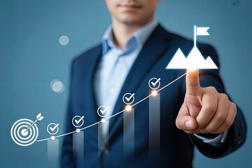 Businessman's finger points to success goal flag on a mountain peak chart