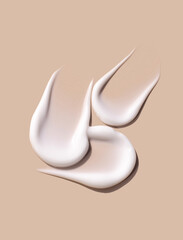 sample smears of creamy white texture on light beige background