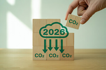 Hand adding cloud puzzle piece symbolizing carbon reduction by 2026 for environmental sustainability