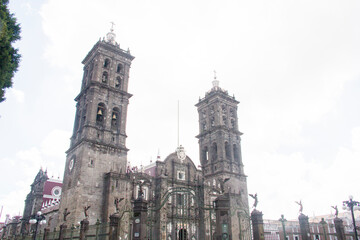 Full view of Puebla Cathedral showcasing its intricate Baroque architecture and detailed metalwork, captured from a clean perspective with no street distractions.