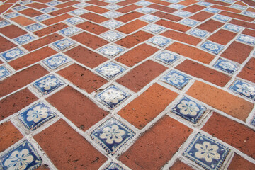 Detailed view of red bricks with colorful talavera tiles, highlighting Mexico&rsquo;s unique colonial Baroque architectural style.