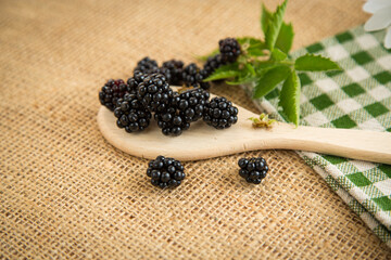 Ripe berries on table with fabric and greenery
