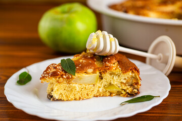 Airy pastries with apple slices and a mint sprig for serving