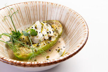 Fried avocado and cream cheese on a plate.