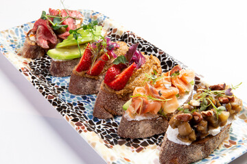Various bruschettas on a plate.