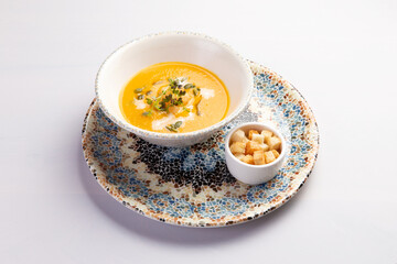 Traditional pumpkin soup in a bowl.