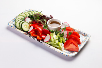 Vegetable platter. Tomatoes, bell peppers, cucumbers, and radishes.