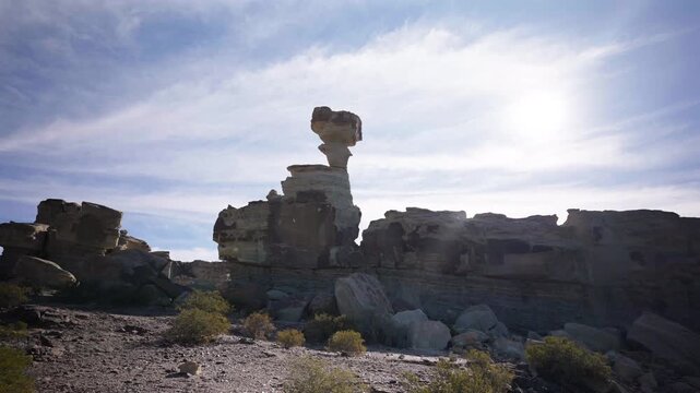 A beautiful, backlit shot of "The Mushroom" (El Hongo), the most famous and iconic rock formation in Argentina's Valley of the Moon (Valle de la Luna), Ischigualasto Park.