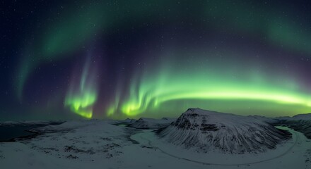 Vibrant northern lights displayed over snow covered mountains and landscape