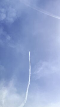 Ascending Vapor Trail in Azure Sky: A soaring vapor trail etches a delicate line across a vast expanse of azure sky, a testament to the power of flight and the boundless horizons of possibility.