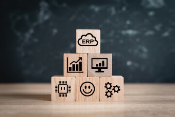 Concept of Enterprise Resource Planning with wooden blocks showing icons for data, technology, automation, and user experience