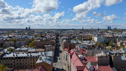 Aerial Drone View Of Riga Panorama In Latvia On A Sunny Spring Day Showcasing The Rooftops Of Houses The Vibrant City Center Historic Buildings And Barona Street Playground of the Downtown Sports Area