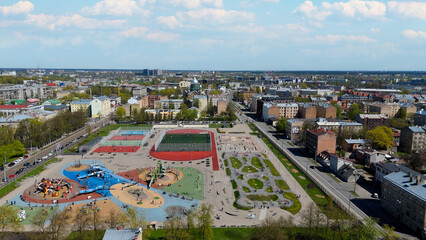 Aerial Drone View Of Riga Panorama In Latvia On A Sunny Spring Day Showcasing The Rooftops Of Houses The Vibrant City Center Historic Buildings And Barona Street Playground of the Downtown Sports Area