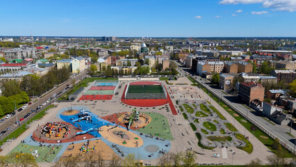 Aerial Drone View Of Riga Panorama In Latvia On A Sunny Spring Day Showcasing The Rooftops Of Houses The Vibrant City Center Historic Buildings And Barona Street Playground of the Downtown Sports Area