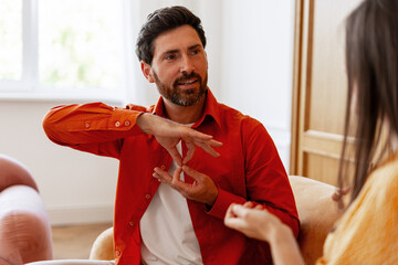 Bearded middle aged man performing sign language communicating with woman © Maria Vitkovska