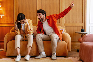Couple experiencing conflict shouting during relationship argument at home