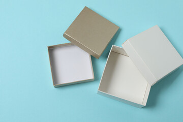 empty paper box with lid on blue background, top view
