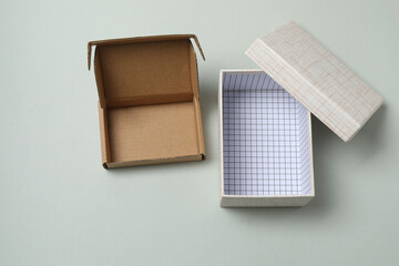 empty paper box with lid on gray background, top view
