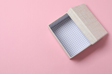 empty paper box with lid on pink background, top view
